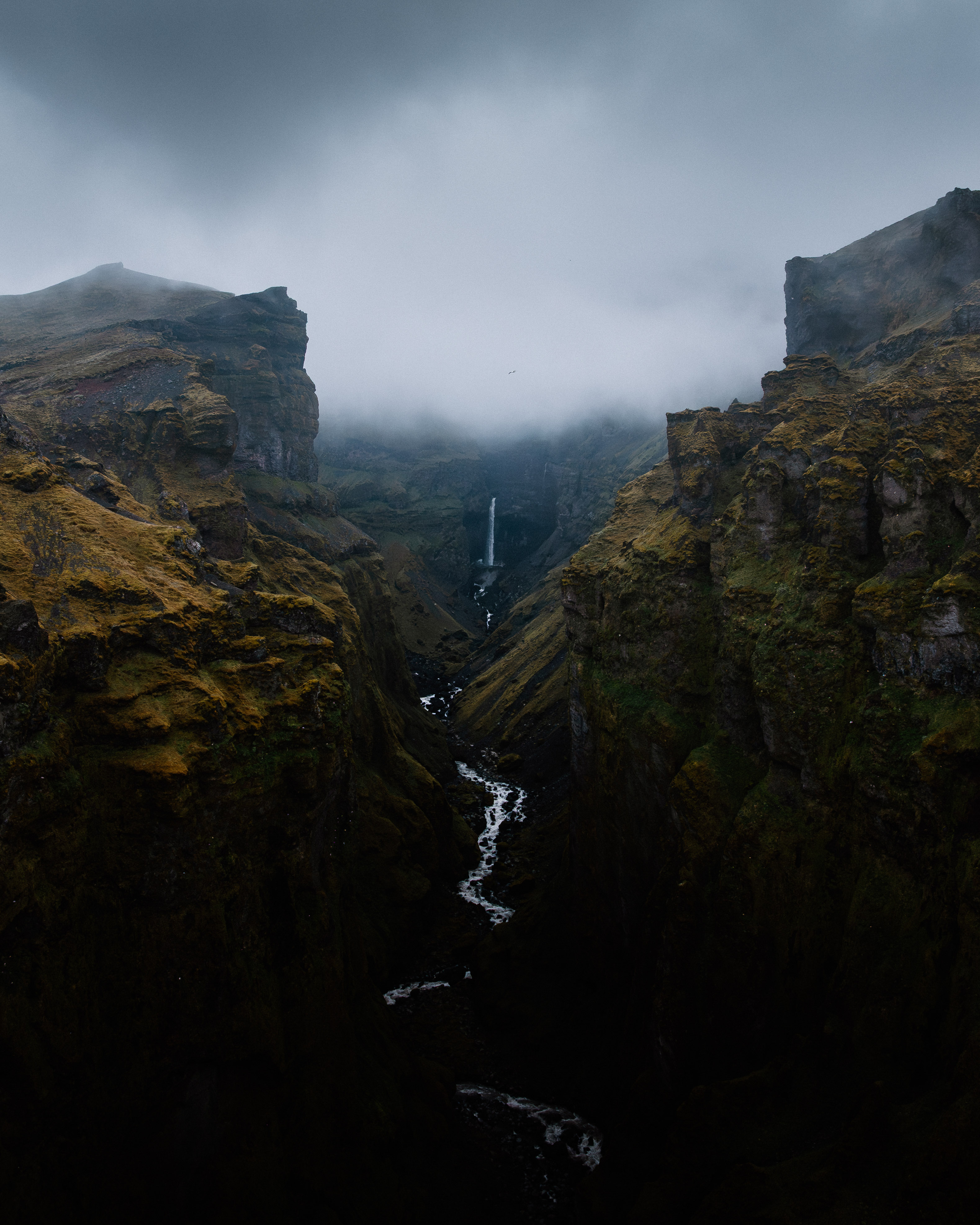 A river between two cliffs in fog
